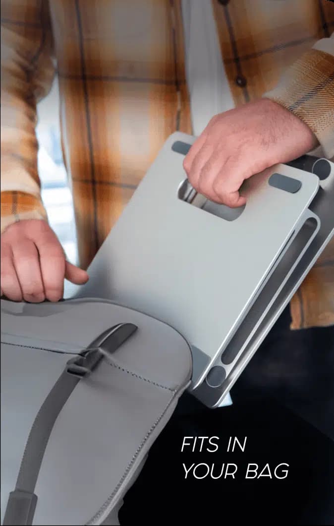 A folded DriftDesk laptop stand sliding into a shoulder bag